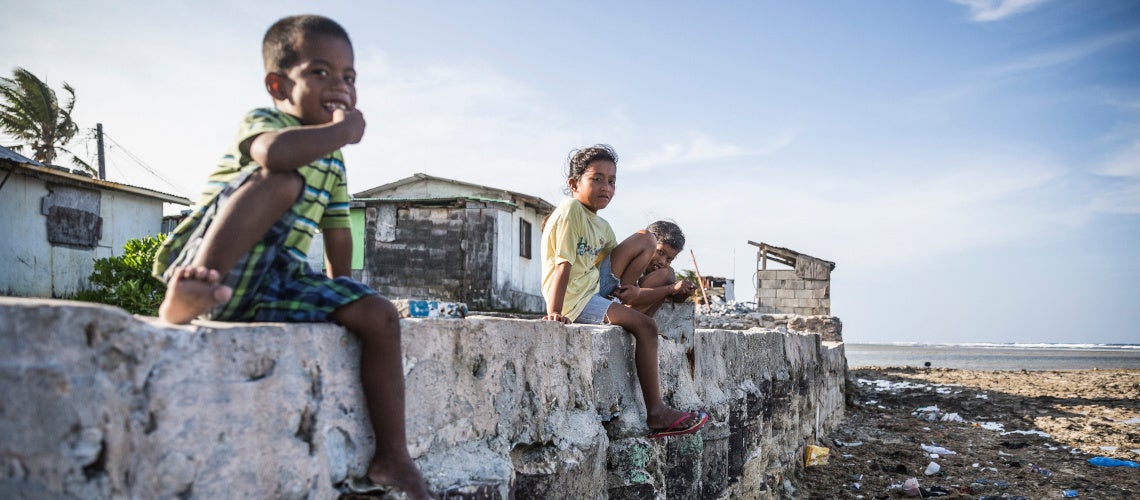 Marshall Islands ? Children sitting on a seawall near their family houses. Their home village of Jenrok in Majuro is slowly being destroyed by the rising seas. Marshall Islands ? Children sitting on a seawall near their family houses. Their home village of Jenrok in Majuro is slowly being destroyed by the rising seas.