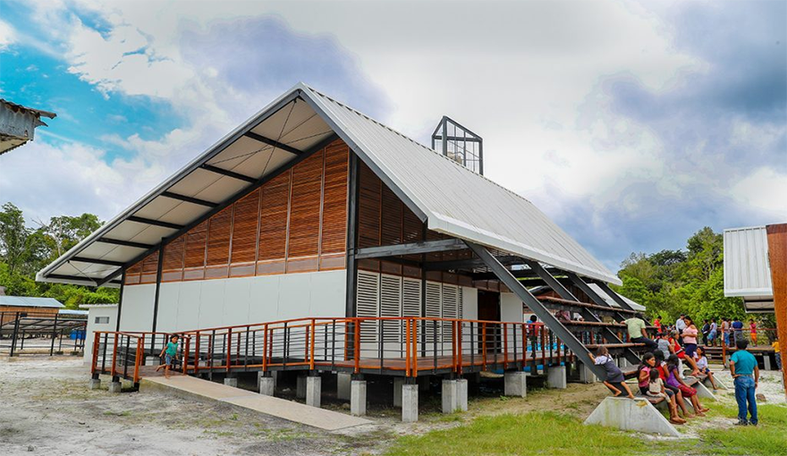 Students sit outside of an improved school