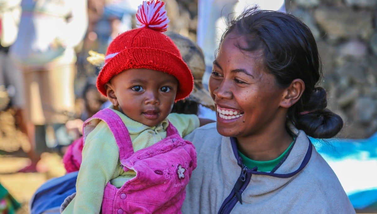 A young mother and her baby visit the local nutrition center in rural Madagascar to participate in a discussion around children's nutrition and learn new cooking recipes that promote a varied diet. A young mother and her baby visit the local nutrition center in rural Madagascar to participate in a discussion around children's nutrition and learn new cooking recipes that promote a varied diet.