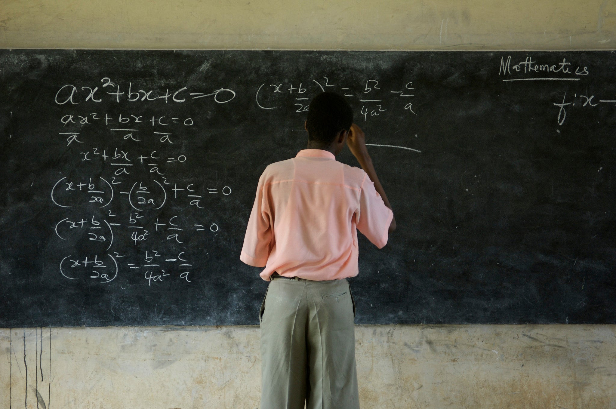A student solves a mathematics equation A student solves a mathematics equation
