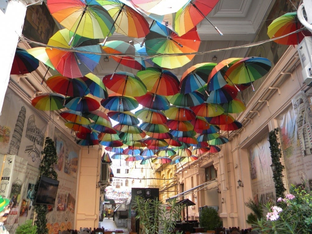 Tucked behind one of the 349 ?red dots? buildings in the Old Town of Bucharest, colorful umbrellas in Pasajul Victoria remind us that community-led initiatives are transforming Bucharest as a dynamic environment. Source: Britchi Mirela/Wikimedia Commons
