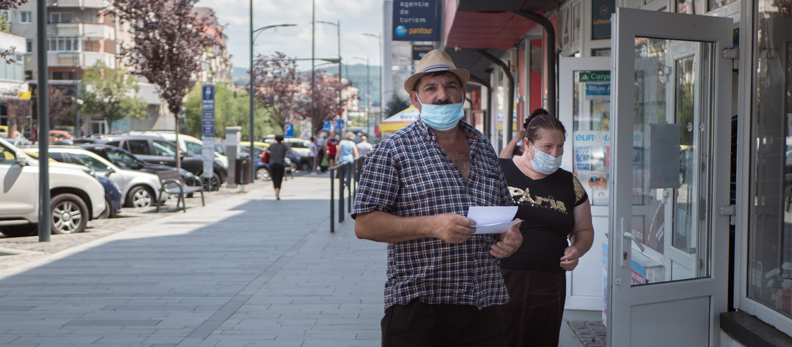 Ramnicu Valcea, Romania - July 2020: People on the street during the covid-19 pandemic on a sunny noon Ramnicu Valcea, Romania - July 2020: People on the street during the covid-19 pandemic on a sunny noon
