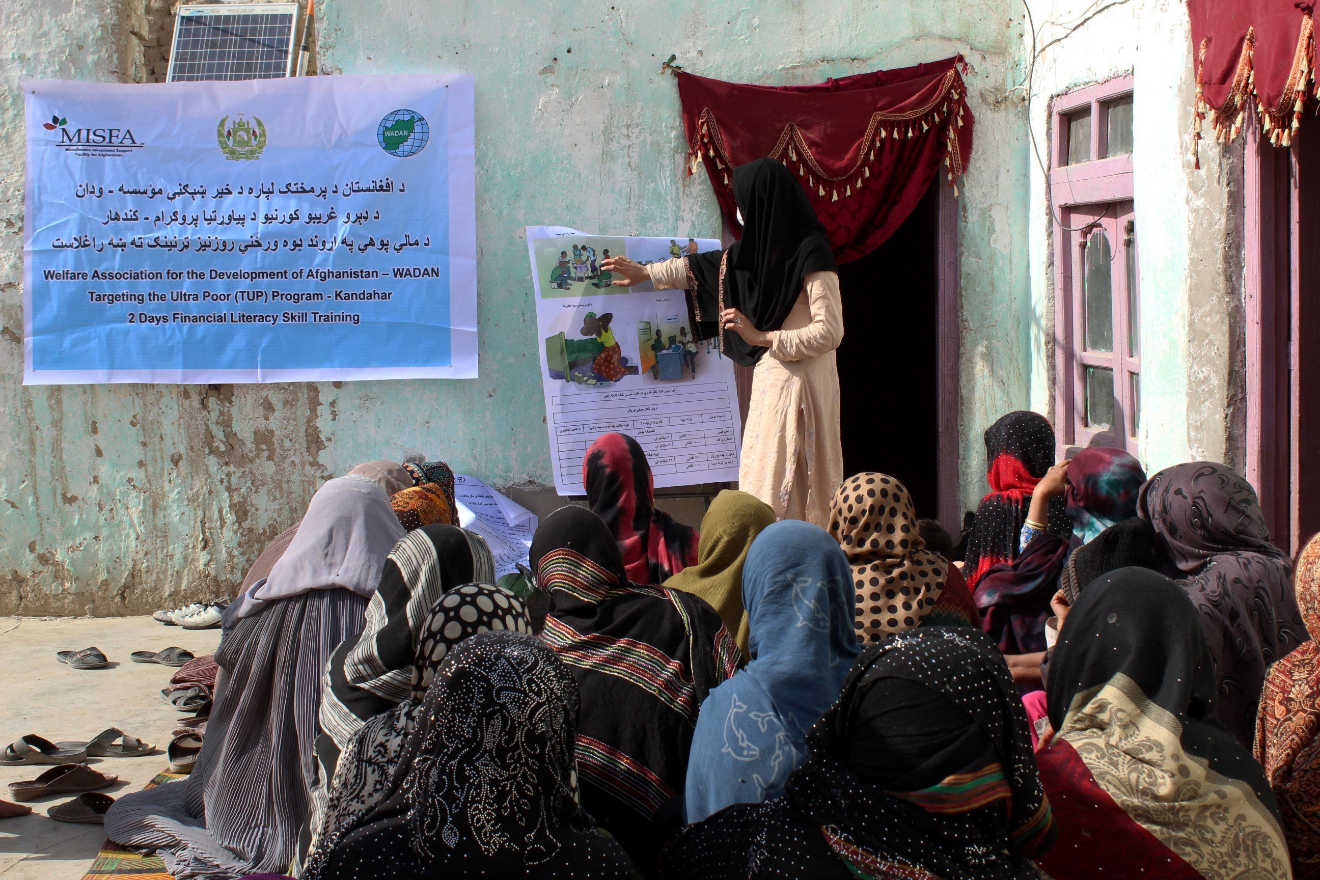 A group of women in Kandahar attend a financial literacy class to learn about the importance of saving and how to access local financial institutions. Photo: © Microfinance Investment Support Facility for Afghanistan