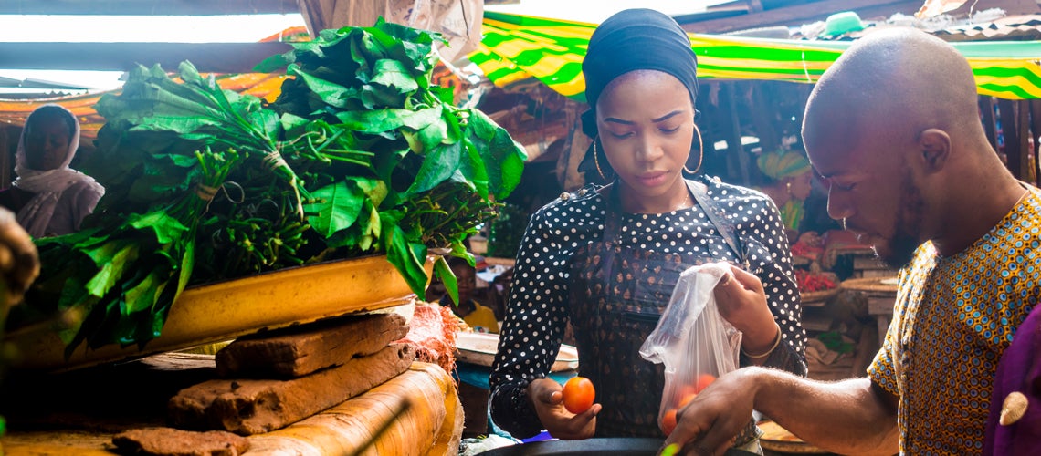 A woman sells goods in an African market. Photo credit: Shutterstock A woman sells goods in an African market. Photo credit: Shutterstock