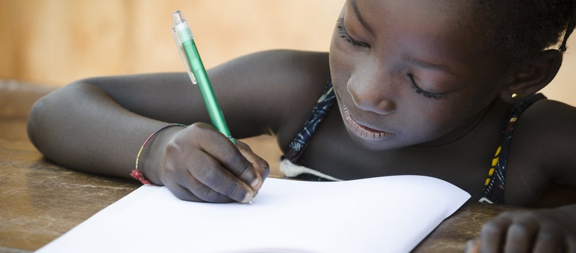 a young girl does homework at a school in Africa a young girl does homework at a school in Africa