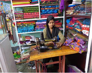 Dolly working in her tailoring shop 