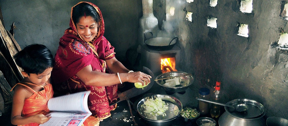 Ms. Shefali Ghosh from Savar, near Dhaka, teaches her daugher in the kitchen. Ms. Shefali Ghosh from Savar, near Dhaka, teaches her daugher in the kitchen.