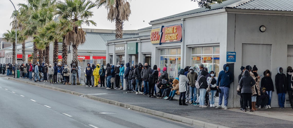 Lines of people waiting for financial assistance in Cape Town. Shutterstock.