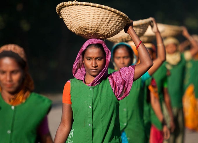 Bangladeshi women holding basket above their heads while working on road project. The Second Bangladesh Rural Transport Improvement Project interventions have created approximately 50,000 person-years of employment in project areas, out of which 30% were for poor women.