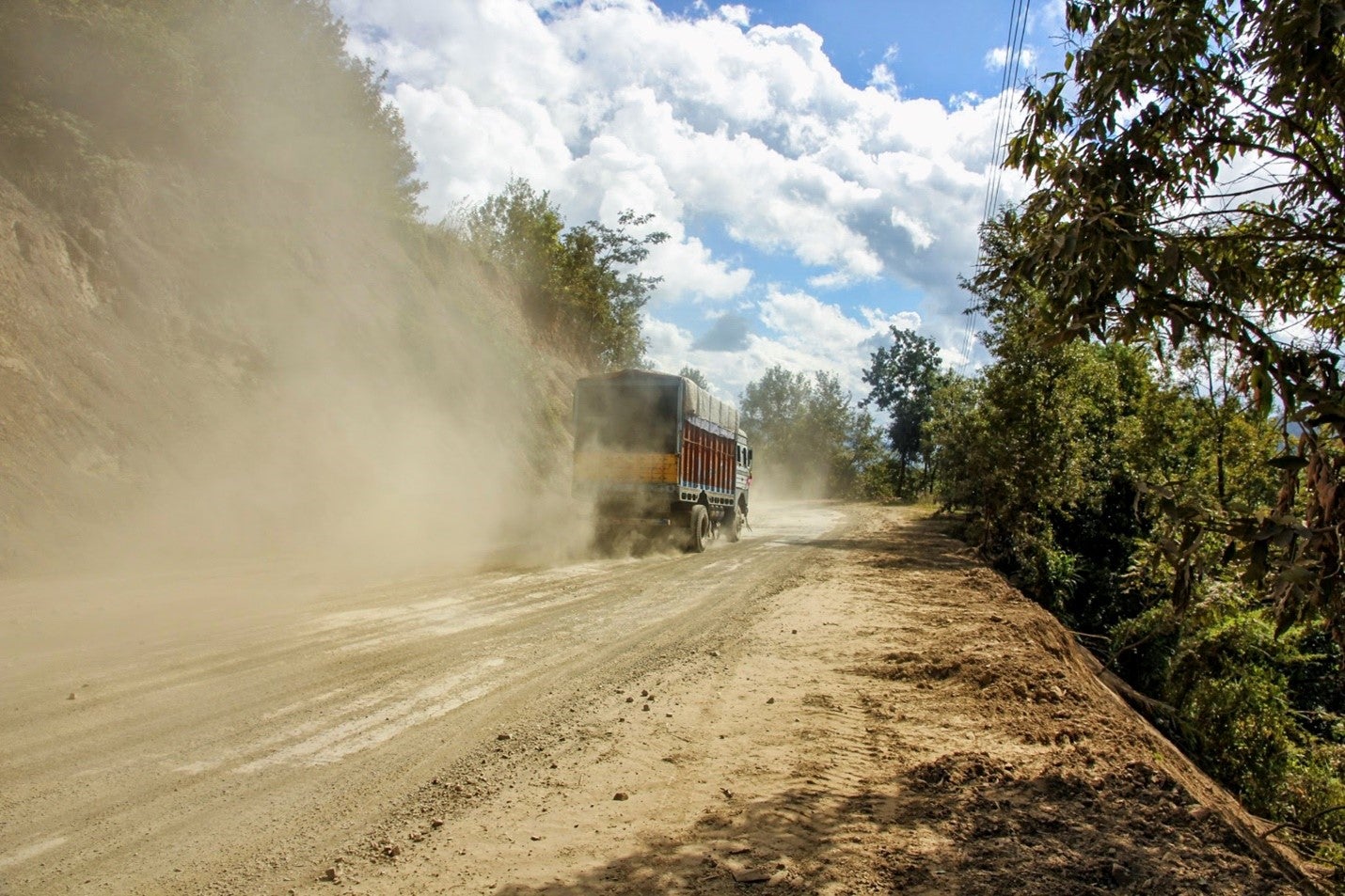 A truck moving on a dusty road in Northeast India. Photo: Srinivasan Balaji/ Shutterstock A truck moving on a dusty road in Northeast India. Photo: Srinivasan Balaji/ Shutterstock