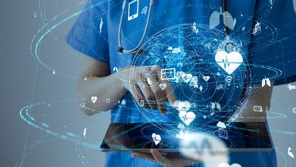 A physician uses a tablet for their work