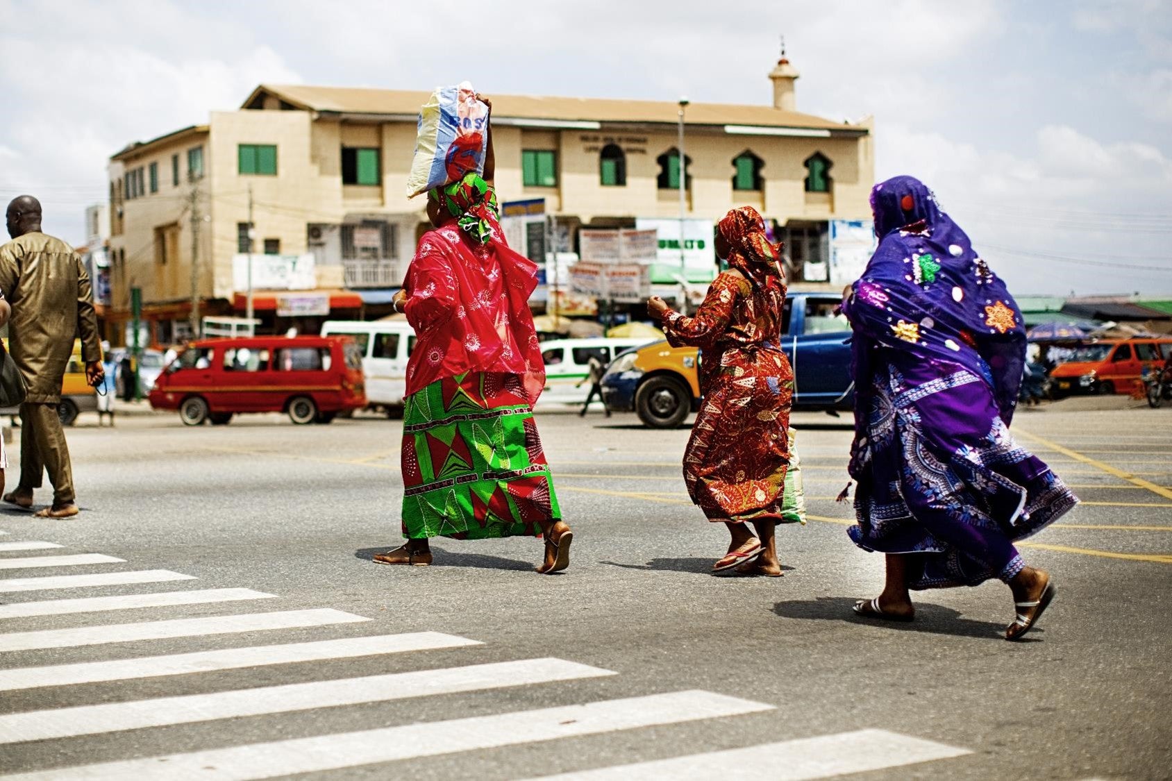 Women crossing busy road in Accra, Ghana