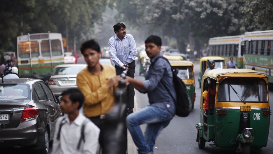 Pedestrians atop a fence to cross a busy road in New Delhi, India. Credit: Anindito Mukherjee/Reuters Pedestrians atop a fence to cross a busy road in New Delhi, India. Credit: Anindito Mukherjee/Reuters