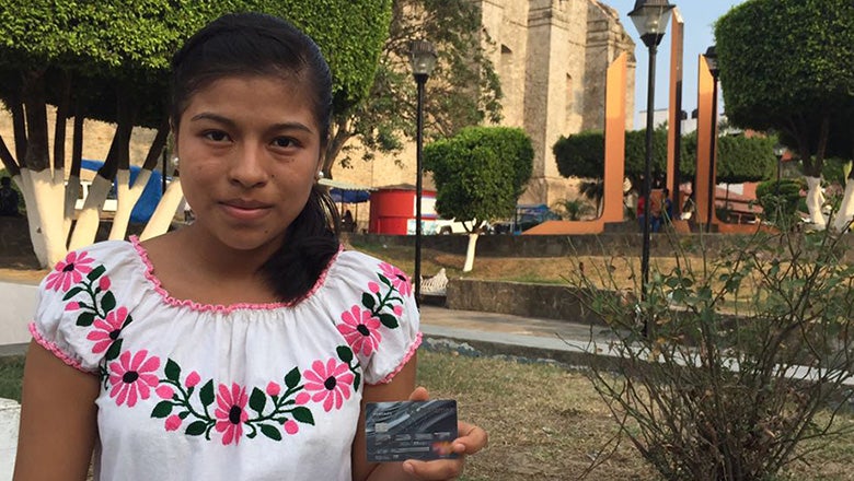 A girl with a bankcard in Mexico. Photo: Alberto Canche/ World Bank
