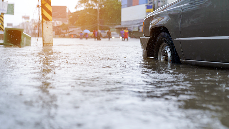 flood water-people walking in the rain on flooded road. Photo credit: thanatphoto/Shutterstock flood water-people walking in the rain on flooded road. Photo credit: thanatphoto/Shutterstock