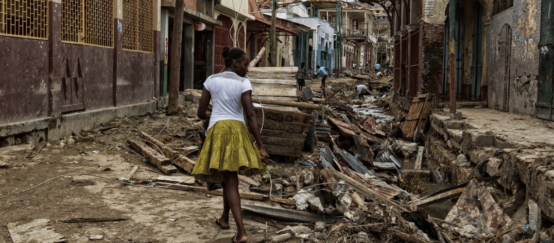 A woman walks through the rubbles in downtown Jeremie Haiti, following the passage of Hurricane Matthew in 2016.  