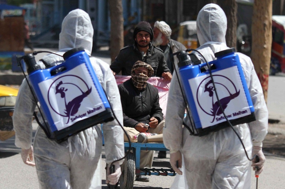 Afghan workers spray disinfectants at public areas in Herat, Afghanistan.