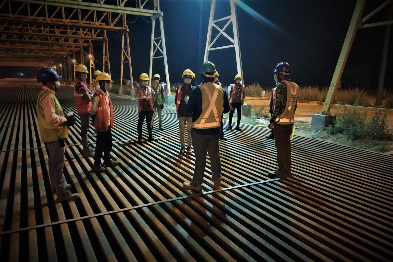 Workers maintaining social distance and wearing masks at the EDFC project site, India