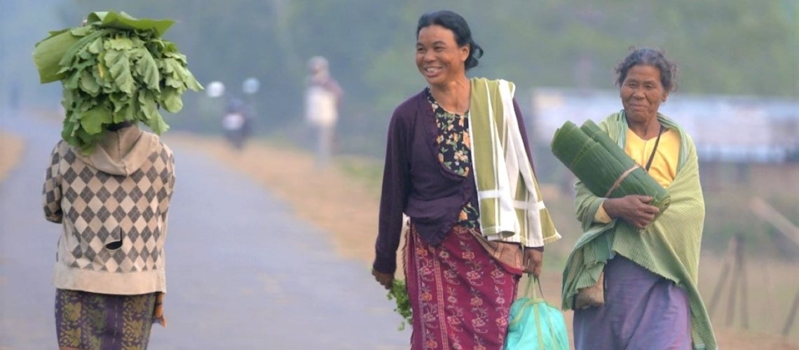 Women walking in new rural road in PMGSY