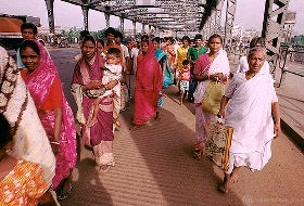 Women walking by a road in India