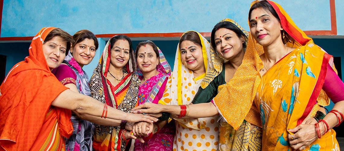 Group of traditional indian women wearing colorful sari. | © Adobe Stock