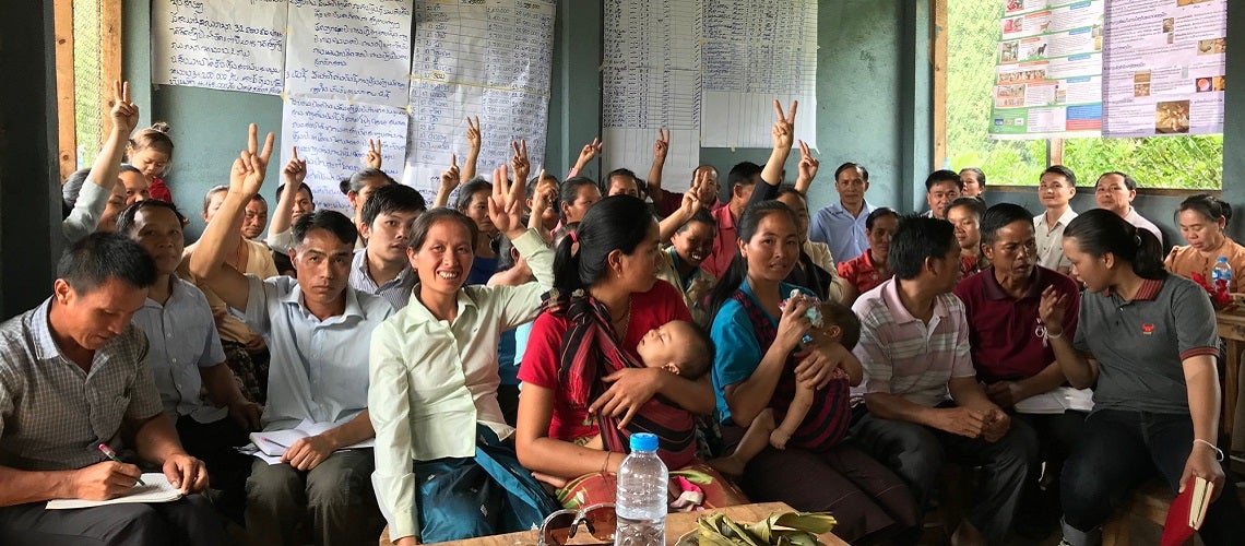 Self Help Groups members raise their hands to indicate how many livelihood loans they have borrowed from the group savings. Hiem District, Houaphanh Province, Lao PDR Self Help Groups members raise their hands to indicate how many livelihood loans they have borrowed from the group savings. Hiem District, Houaphanh Province, Lao PDR