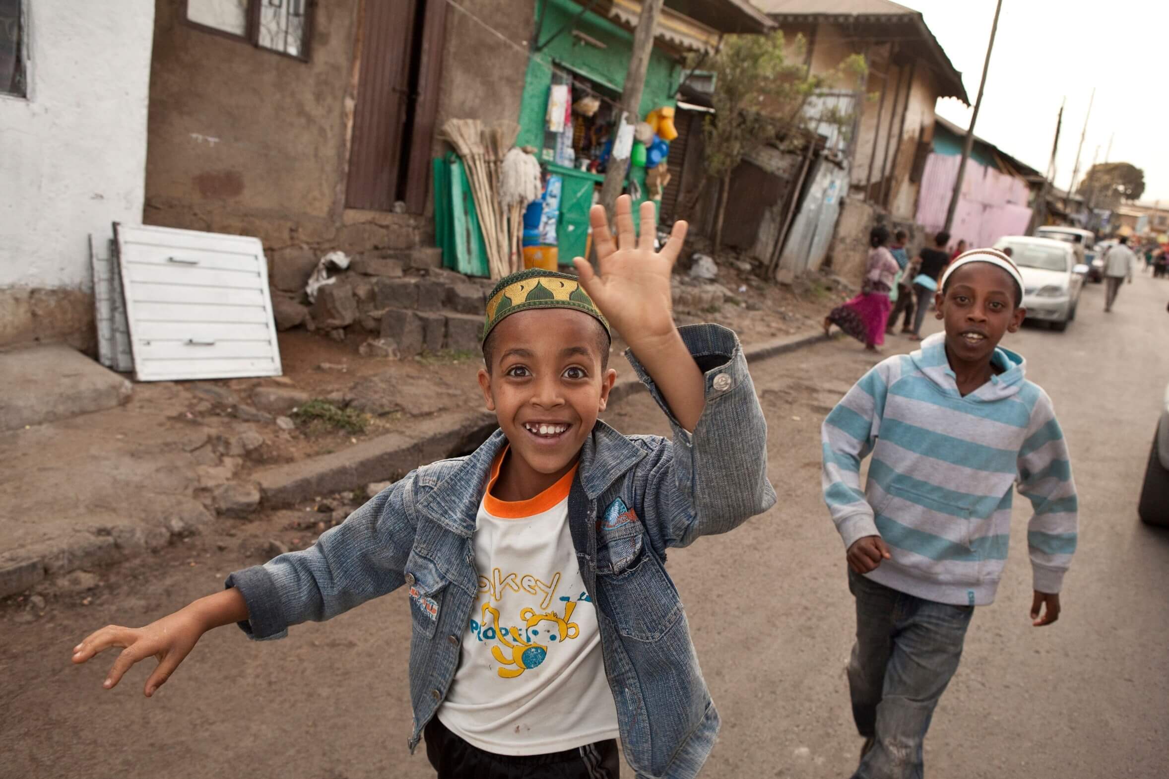 Young Ethiopian children run on the street in their neighborhood