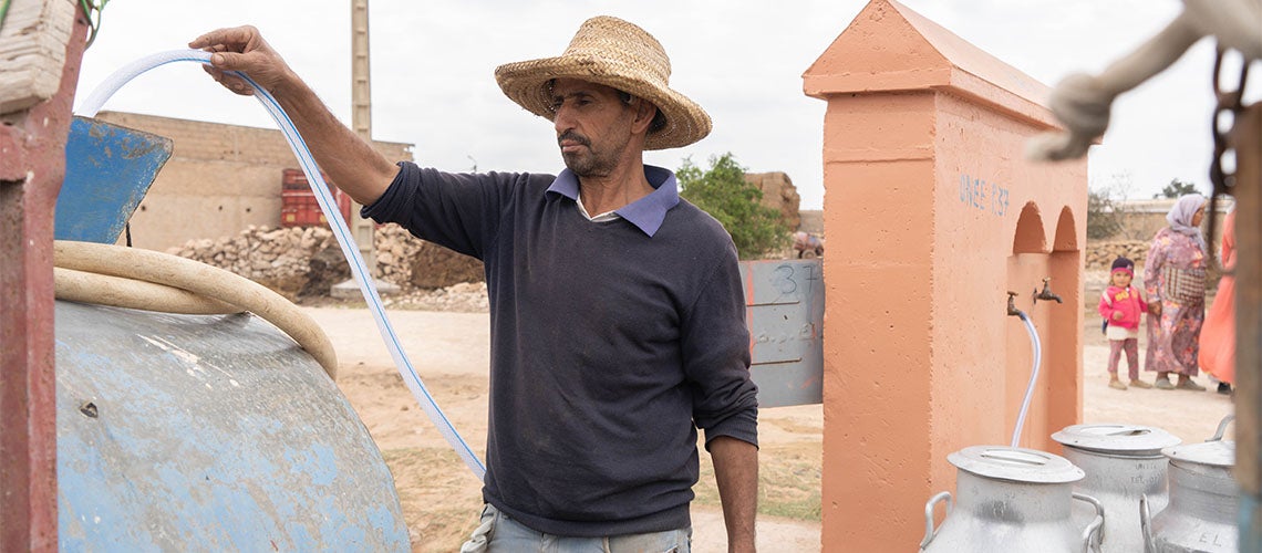 Man filling water tank