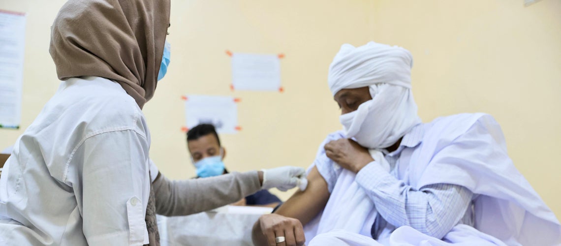 A female health care worker vaccines a man against Covid-19 at the Maughataa Medical Center in Teyarett, Mauritania. Photo credit: World Bank A female health care worker vaccines a man against Covid-19 at the Maughataa Medical Center in Teyarett, Mauritania. Photo credit: World Bank