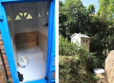 A new toilet in Nangkhel village, with tiles, mirror and showerhead?next to a house without electricity