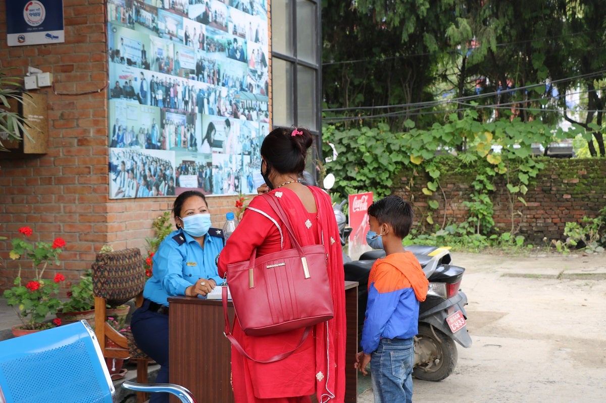 A police officer counsels a woman and her child