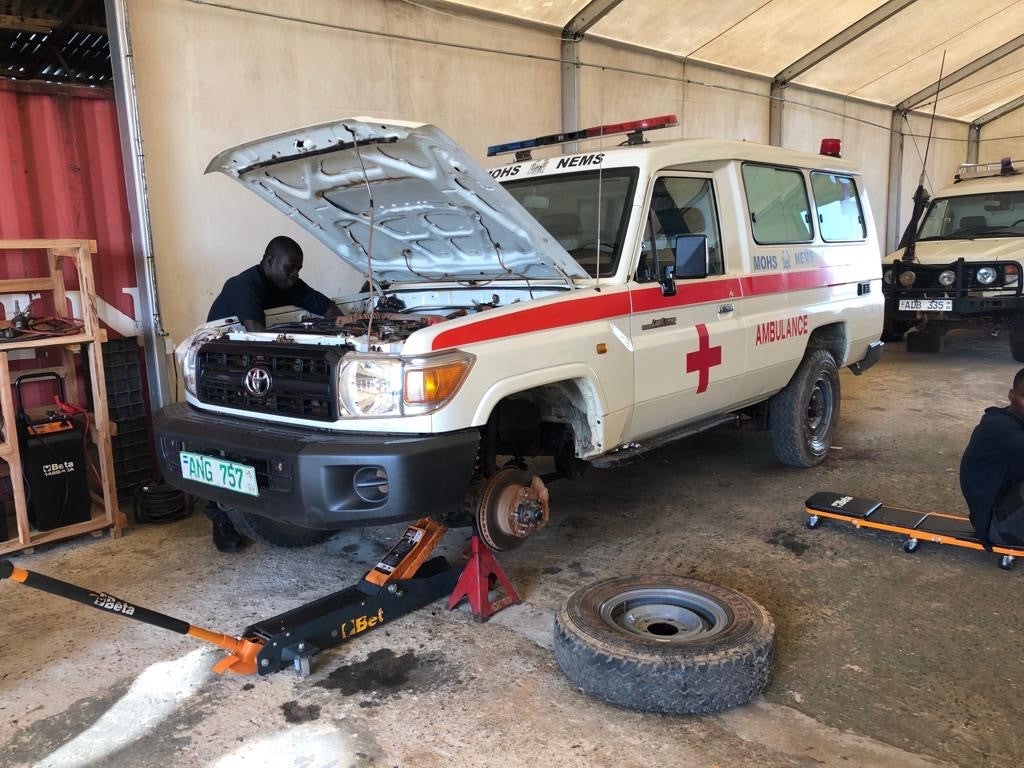 At the main workshop at Hasting, Western Area Rural, Sierra Leone, a NEMS mechanic performs repairs to a NEMS ambulance. 