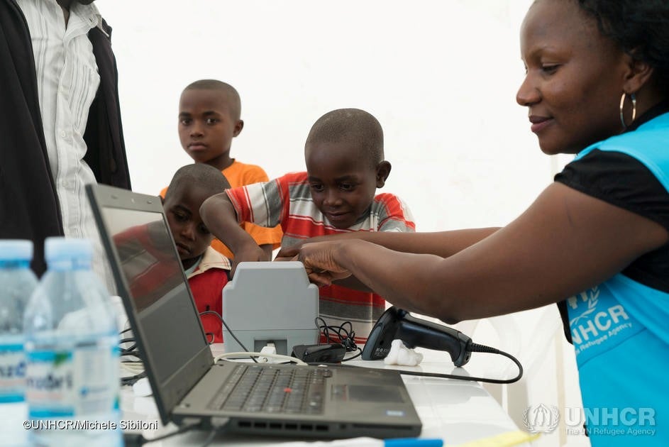 UNHCR staff member Winnie Mugisa is hard at work verifying Congolese refugees using the biometric equipment at Oruchinga settlement in Uganda.
