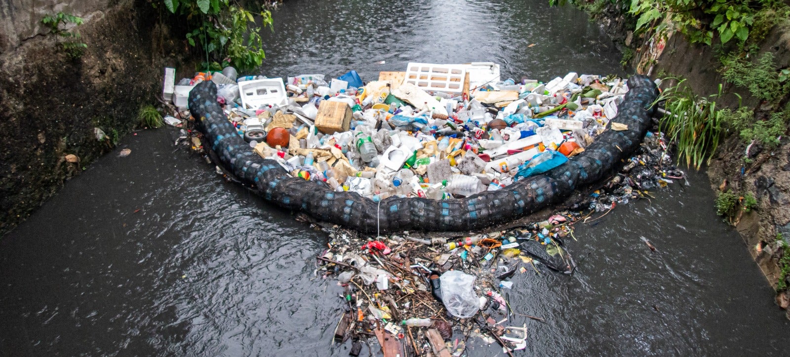 Low cost garbage filtering system that catches all forms of rubbish in a dirty flowing river in Cebu City, Philippines.