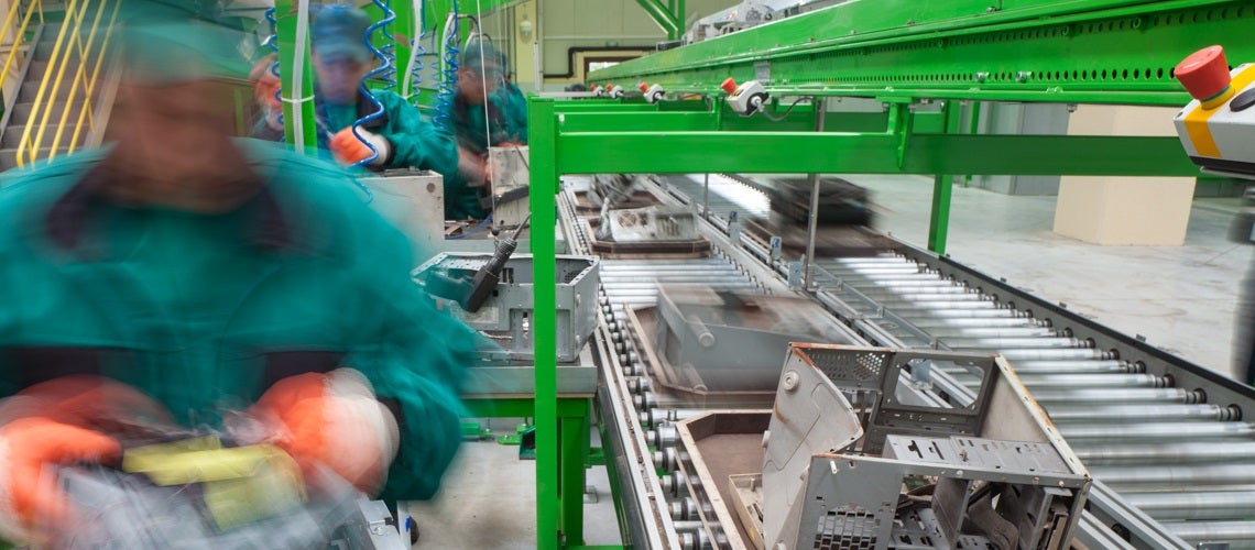 Workers sorting electronics components for recycling Workers sorting electronics components for recycling