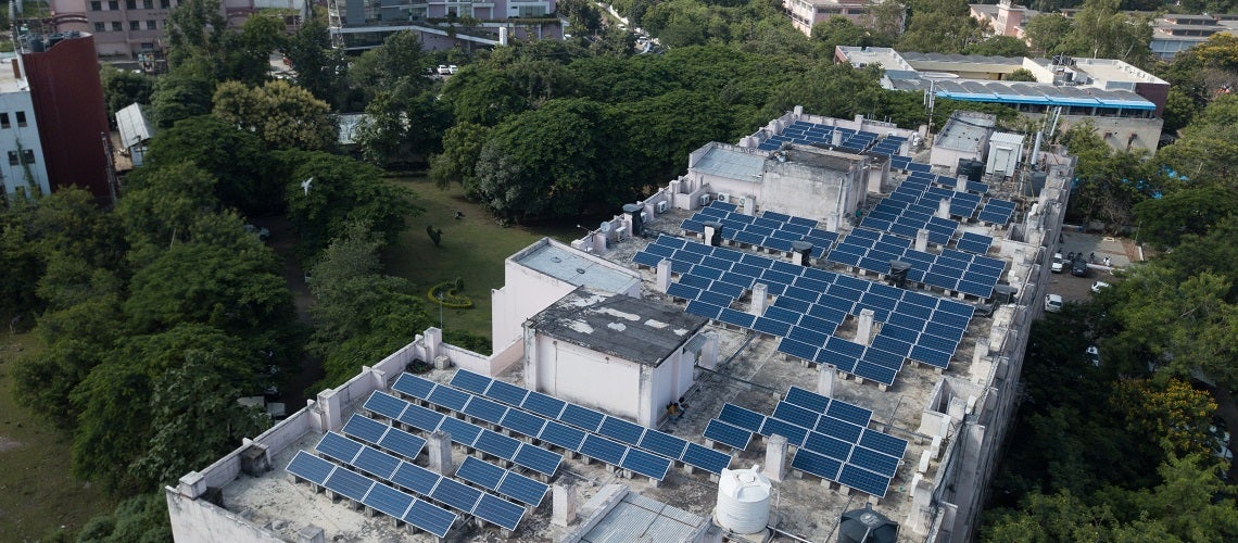 Aerial view of rooftop solar panels in buildings in India. 