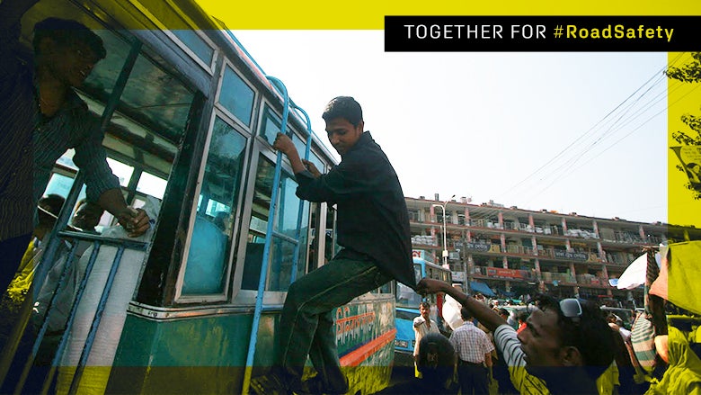 Road Safety: A young man climbs a bus. Road Safety: A young man climbs a bus.