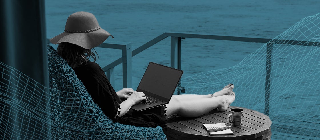 Woman working on her laptop at a beach resort in Maldives.