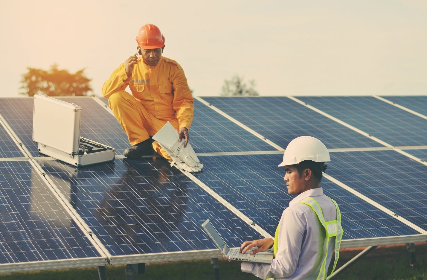 Two men working at a solar power station. Photo: © Sonpichit Salangsing/Shutterstock