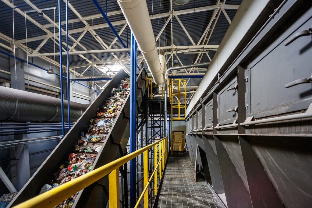 Moving conveyor transporter in a modern waste recycling processing plant.