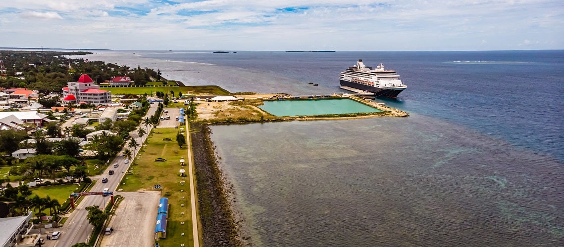 High view of a small pool and a pier with a cruise ship at low tide, Tonga High view of a small pool and a pier with a cruise ship at low tide, Tonga