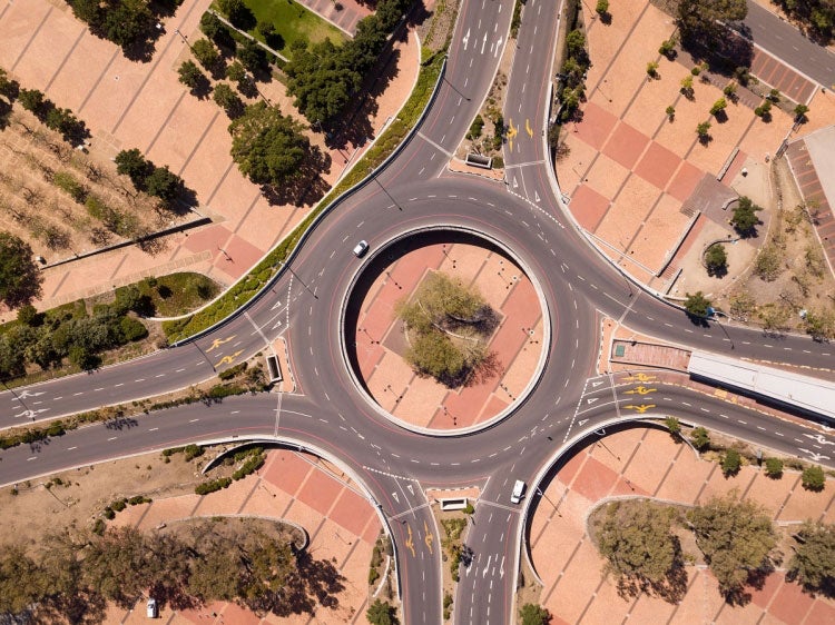 Aerial view over a traffic intersection during COVID-19 lock down, with empty streets. Photo: © fivepointsix/Shutterstock