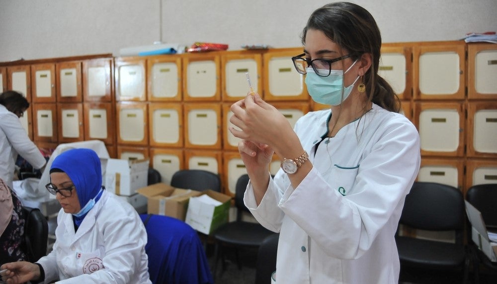Women in vaccination center. Hasan Mrad/Shutterstock.com