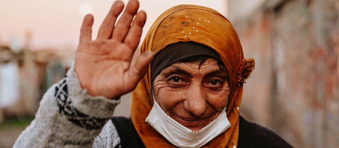 A Turkish woman who received a digital government payment for social assistance waives at the camera A Turkish woman who received a digital government payment for social assistance waives at the camera