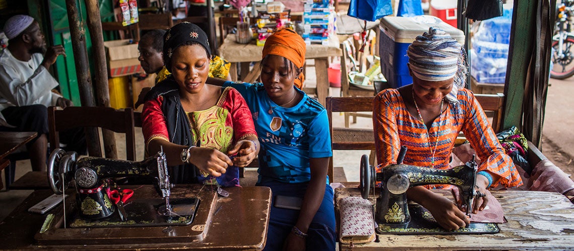 Young women work at sewing clothes in the market. Photo credit: Vincent Tremeau /World Bank