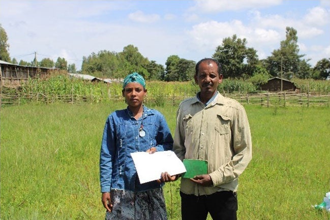 Addise Grimaw and Abi Alamirew, a small holder farming couple, from Dangla Woreda of Amhara Region with their certification for second level landholding. 