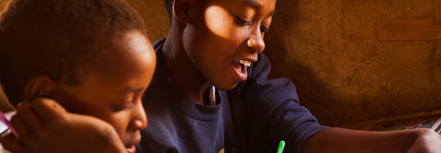 Two pupils reading school material in their classroom in Hombolo Bwawani, Tanzania. Copyright: Arne Hoel / World Bank