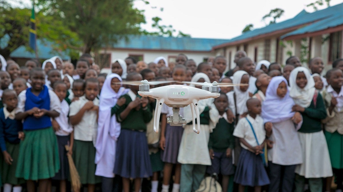Children and local residents watch drone trials in the Lake Victoria region, Tanzania. Photo: Chris Morgan/World Bank