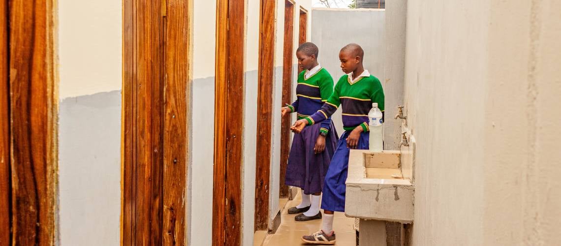 Girls at Filimule Primary School in Katavi, Tanzania, use the washroom, recently built with support from the Sustainable Rural Water Supply and Sanitation Program (SRWSSP).