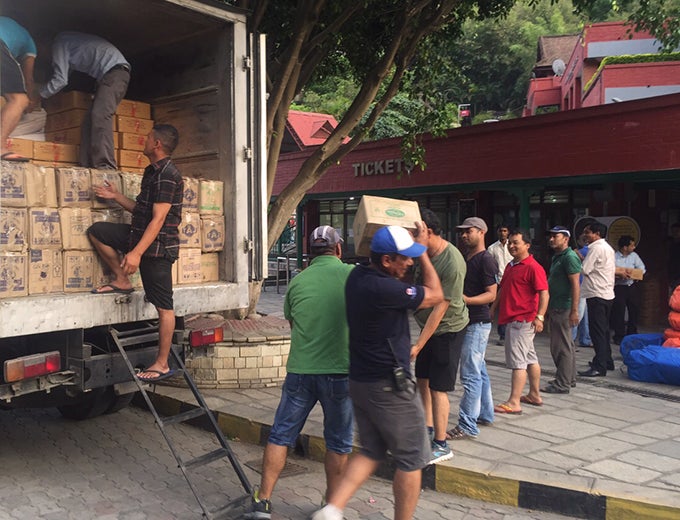 Volunteers unload relief materials in Nepal